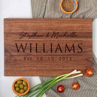 A wooden cutting board with the name stephanie and williams.