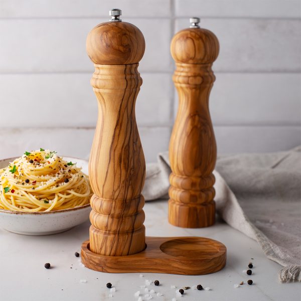 Olive wood salt and pepper mills with a bowl of pasta