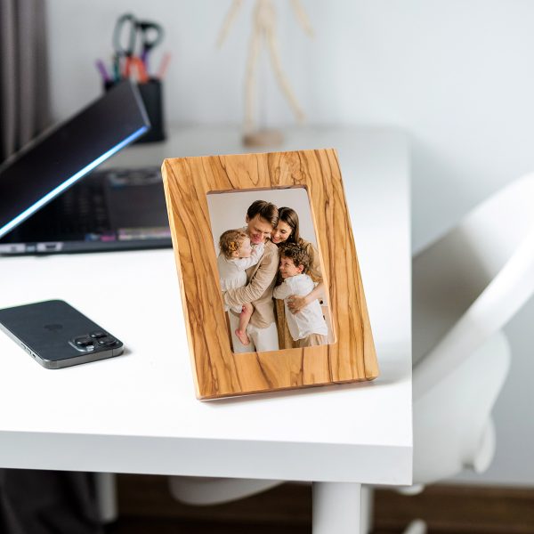 Olive wood photo frame standing upright on a desk