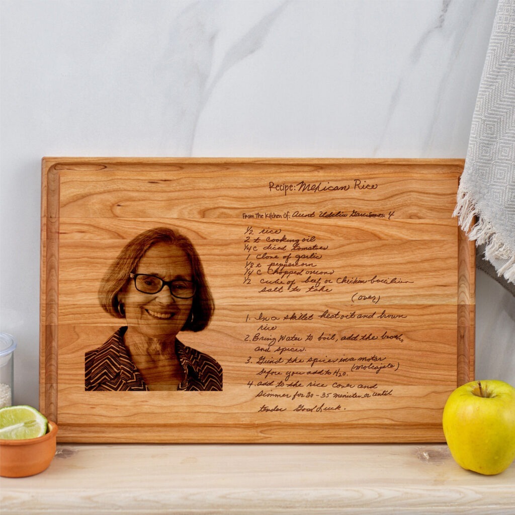 A wooden recipe cutting board with engraved recipe and a picture of a woman.