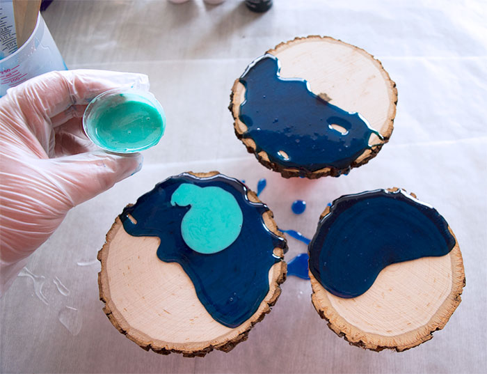 pouring paint on wood slices