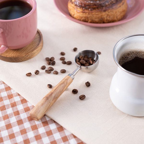 Olive wood coffee scoop with whole coffee beans