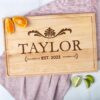 A personalized wooden cutting board with the name, ideal as a wood wedding gift.