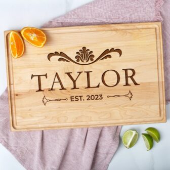 A personalized wooden cutting board with the name, ideal as a wood wedding gift.