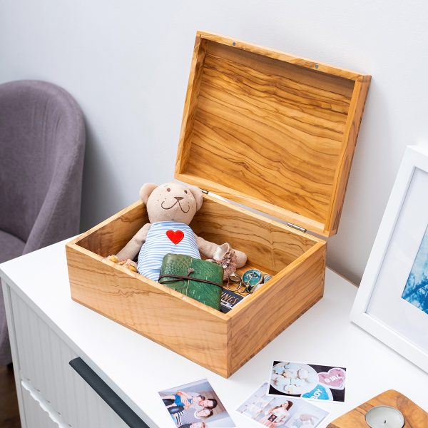 Olive wood memory box holding baby keepsakes and a teddy bear